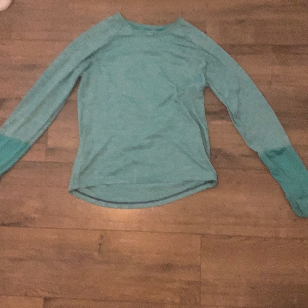This is a teal colored and is a long sleeve shirt.